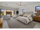 Spacious main bedroom featuring neutral tones, modern lighting, and access to a private outdoor retreat at 24863 N 103Rd Way, Scottsdale, AZ 85255