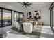Bright home office with modern finishes, dual abstract art pieces, a large desk, and two furry, white chairs at 24863 N 103Rd Way, Scottsdale, AZ 85255