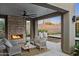 Inviting outdoor living space featuring a stone fireplace and serene views of desert landscape at 24863 N 103Rd Way, Scottsdale, AZ 85255