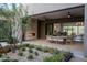 Charming outdoor patio with stone fireplace and dining area; perfect for entertaining guests at 24863 N 103Rd Way, Scottsdale, AZ 85255