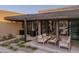 Stylish outdoor patio with comfortable seating, lush landscaping and a seamless flow to indoor living spaces at 24863 N 103Rd Way, Scottsdale, AZ 85255