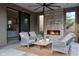 Inviting patio with a stone fireplace, comfortable seating, and seamless indoor-outdoor living at 24863 N 103Rd Way, Scottsdale, AZ 85255