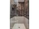 Modern shower with gray tile, glass door, and brass hardware at 24863 N 103Rd Way, Scottsdale, AZ 85255