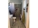 Cozy bathroom featuring a shower with gray tile, plus gray floors and neutral walls at 2501 E Pebble Beach Dr, Tempe, AZ 85282
