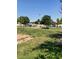 Community playground with playground equipment and basketball hoops in a grassy area at 2501 E Pebble Beach Dr, Tempe, AZ 85282