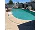 Inviting pool with a basketball hoop and artificial rock structure, surrounded by concrete at 2501 E Pebble Beach Dr, Tempe, AZ 85282