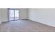 Carpeted living room showing sliding glass doors leading to outdoor patio at 25602 W Coles Rd, Buckeye, AZ 85326