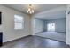 Bright, open-concept living room with wood floors, and a view into the living area with carpet at 25602 W Coles Rd, Buckeye, AZ 85326