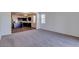 Bright living room with carpet and adjoined kitchen at 25602 W Coles Rd, Buckeye, AZ 85326