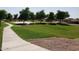 Scenic park view with sidewalks, mature trees and playground offering a relaxing outdoor space at 25602 W Coles Rd, Buckeye, AZ 85326