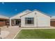 The backyard has a cozy patio, a well-manicured artificial lawn, and drought-tolerant desert plants at 25915 W Tina Ln, Buckeye, AZ 85396