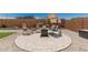 Outdoor seating area with a fire pit, patio furniture, and desert landscaping provide a relaxing atmosphere at 25915 W Tina Ln, Buckeye, AZ 85396