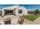 Well-maintained backyard featuring a patio, artificial grass, and desert landscaping, ideal for outdoor enjoyment at 25915 W Tina Ln, Buckeye, AZ 85396