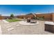 Spacious backyard featuring a turfed play area, a seating area with a fire pit, and desert landscaping at 25915 W Tina Ln, Buckeye, AZ 85396