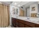 Well-lit bathroom features a double vanity with stylish faucets and mirrors, and a shower at 25915 W Tina Ln, Buckeye, AZ 85396