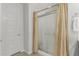 Clean bathroom showcases a shower with glass door, neutral curtain, and white door at 25915 W Tina Ln, Buckeye, AZ 85396