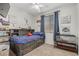 Bright bedroom with a bed, window, closet, and carpet flooring, decorated with sports art at 25915 W Tina Ln, Buckeye, AZ 85396
