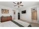 Stylish bedroom boasts modern ceiling fan, king-size bed, and ensuite access at 25915 W Tina Ln, Buckeye, AZ 85396