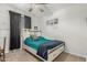 Cozy bedroom features a ceiling fan, a full-sized bed with drawers and decorative wall art at 25915 W Tina Ln, Buckeye, AZ 85396