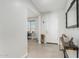 Bright entryway featuring neutral walls, tiled floors, and a console table, leading to a home office at 25915 W Tina Ln, Buckeye, AZ 85396
