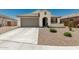 Charming single-story home with desert landscape and a concrete driveway, perfect for low-maintenance living at 25915 W Tina Ln, Buckeye, AZ 85396