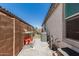Side yard with gravel ground cover, AC unit, and a side gate to the backyard at 25915 W Tina Ln, Buckeye, AZ 85396