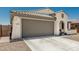 Charming home with a large garage, concrete driveway, and a low-maintenance desert-style landscape at 25915 W Tina Ln, Buckeye, AZ 85396