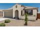 Beautiful single-story home with desert landscape, tile roof, arched entry, and a neutral color scheme at 25915 W Tina Ln, Buckeye, AZ 85396