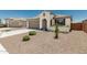 Inviting single-story home with desert landscaping, neutral stucco, and a gray garage door at 25915 W Tina Ln, Buckeye, AZ 85396