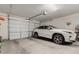 Spacious two-car garage with white door, freshly painted walls, and polished concrete flooring at 25915 W Tina Ln, Buckeye, AZ 85396