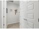 Bright hallway with tiled flooring and neutral walls leading to bedrooms with closet space at 25915 W Tina Ln, Buckeye, AZ 85396