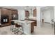 Modern kitchen with granite countertops, stainless steel appliances, and a stylish island with seating at 25915 W Tina Ln, Buckeye, AZ 85396