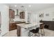 Well-lit kitchen featuring a center island, granite counters, stainless hood, and sleek cabinetry at 25915 W Tina Ln, Buckeye, AZ 85396