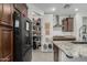 Well-organized kitchen with a walk-in pantry, stainless steel appliances, and stylish countertops at 25915 W Tina Ln, Buckeye, AZ 85396