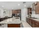 Bright and modern kitchen featuring a large island, stainless steel appliances, and a view to the breakfast area at 25915 W Tina Ln, Buckeye, AZ 85396