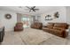 Bright living room with plush leather furniture, stylish decor, and a neutral color palette at 25915 W Tina Ln, Buckeye, AZ 85396