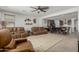 Open-concept living area featuring leather sofas and seamless transition to the dining and kitchen spaces at 25915 W Tina Ln, Buckeye, AZ 85396