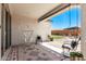 Covered patio featuring decorative rug, hanging hammock chair, and a view of the backyard at 25915 W Tina Ln, Buckeye, AZ 85396
