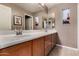 Spacious bathroom featuring double sinks, wood cabinets, and nautical décor at 3065 E Harvard Ave, Gilbert, AZ 85234