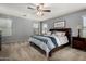 Spacious bedroom featuring a ceiling fan, plush carpet, and a comfortable king-sized bed at 3065 E Harvard Ave, Gilbert, AZ 85234