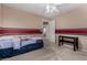 Bedroom with two-tone walls, ceiling fan, and a door that opens to another room at 3065 E Harvard Ave, Gilbert, AZ 85234