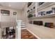 Open hallway with wood floors, stairs, and built-in bookshelves filled with books at 3065 E Harvard Ave, Gilbert, AZ 85234