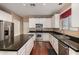Gourmet kitchen with stainless steel appliances, granite countertops, and an island with extra seating and storage at 3065 E Harvard Ave, Gilbert, AZ 85234