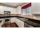 Gourmet kitchen features stainless steel appliances, granite countertops, and white cabinetry at 3065 E Harvard Ave, Gilbert, AZ 85234