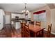Eat-in kitchen boasts a wooden dining table, stainless appliances, white cabinetry, and dark countertops at 3065 E Harvard Ave, Gilbert, AZ 85234