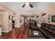 Open floor plan with leather sofas, a dining area, and a kitchen with white cabinets and stainless steel appliances at 3065 E Harvard Ave, Gilbert, AZ 85234