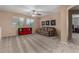 Spacious living room with a ceiling fan, comfortable couch and a decorative bookshelf at 3065 E Harvard Ave, Gilbert, AZ 85234