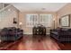 Well-lit living room with hardwood floors, plantation shutters, and cozy seating at 3065 E Harvard Ave, Gilbert, AZ 85234