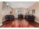 Bright living room with hardwood floors, large windows, and comfortable plaid couches at 3065 E Harvard Ave, Gilbert, AZ 85234