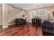 Inviting living room featuring hardwood floors, stairs, and large bright windows at 3065 E Harvard Ave, Gilbert, AZ 85234